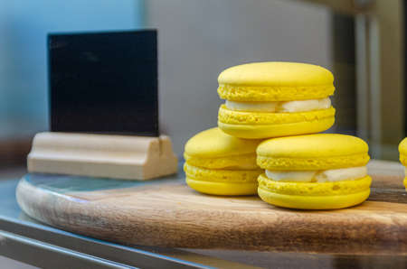 passion fruit pasta cookies.Yellow multi-layer cookies with filling on a wooden stand High quality...