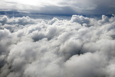 Over beautiful white clouds. From the height of the flight vehicle to the ground. The flight of the...