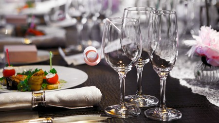 Wine glasses on table covered .の写真素材
