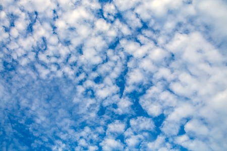 Fancy shapes of flying clouds in blue sky.の写真素材