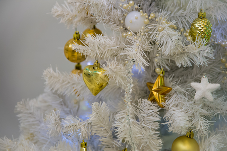 White fir tree with flashing lights garlands. New Year Holiday. Artificial decorated Christmas tree with toys.の写真素材