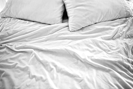 Crumpled bed linen in the morning.の写真素材