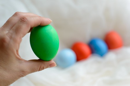 Fun colored eggs painted manually. Handmade food on a subtle texture.