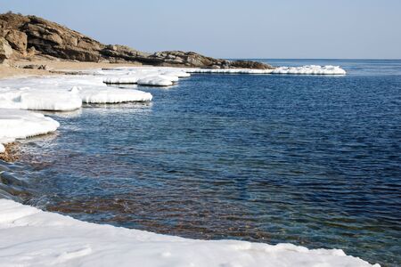 Beautiful nature water frozen in the winter. Landscape snowy expanse to the horizon with a wonderful...