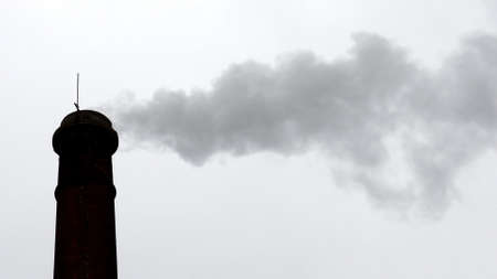 Smoke from the chimney of ancient factory.