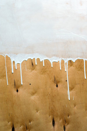 Traces of white paint on plywood.の写真素材