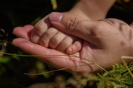 Babys leg is in the mothers hand.の写真素材