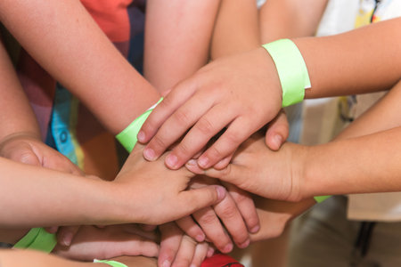 Group of children holding hands together, teamwork concept. Close up.の写真素材