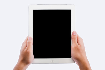 hands holding contemporary generic tablet pc with blank screen. Isolated on white.