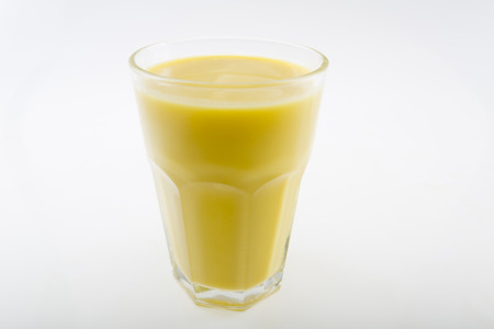 corn milk in glass isolated on white backgroundの写真素材
