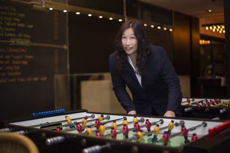 business woman playing foosball