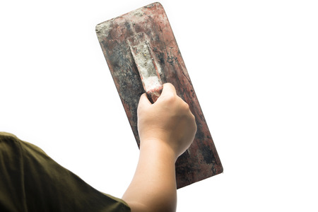 Old trowel in  hand isolated on white backgroundの写真素材