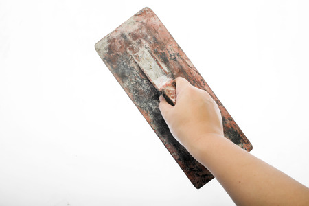 Old trowel in  hand isolated on white background