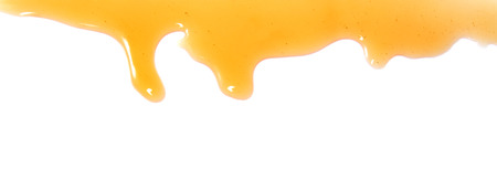 flow of sweet honey on the white backgroundの写真素材