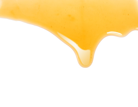 flow of sweet honey on the white backgroundの写真素材