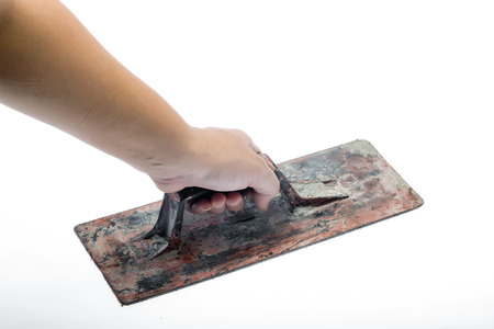 Old trowel in  hand isolated on white backgroundの写真素材