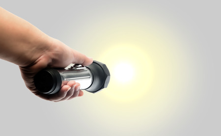 hand holding torch flashlightの写真素材