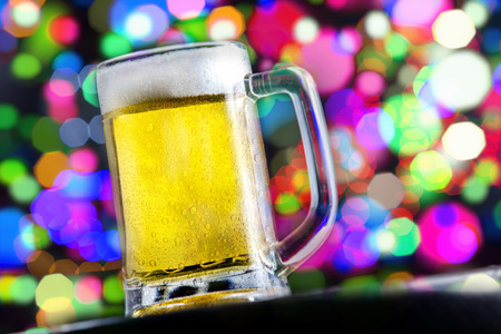 Fresh cold beer on beautiful bokeh backgroundの写真素材