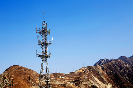 high Telecommunication and high voltage transmission towers on mountain in china
