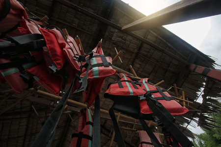 safety vests orange hanging on a raft on the river,save people's lives.の写真素材