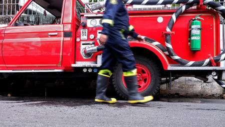 Fireman walking through fire truckの写真素材