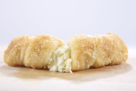 Cream Filled Cone Pastry on a wooden trayの写真素材