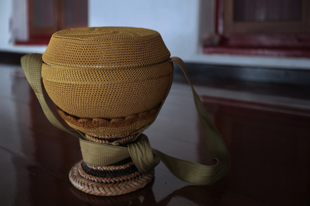 monk's alms bowl ware for take rice and food from people to monk Buddism in Thailand