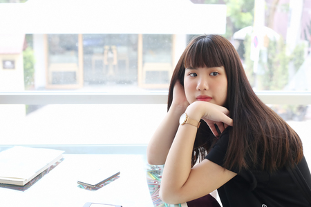 The girl sitting in Absent-mindedの写真素材