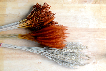 bundles of dried grass on woodの写真素材