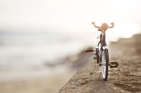 bicycle toy on sunset beach time holidayの写真素材