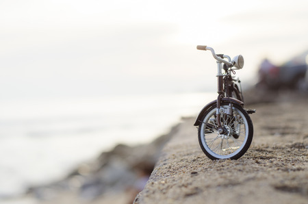 bicycle toy on sunset beach time holidayの写真素材