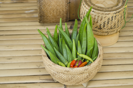 Okra and chili organic in bamboo bastket ready for cook vegetable clean foodの写真素材