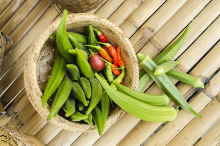 Okra and chili organic in bamboo bastket ready for cook vegetable clean foodの写真素材