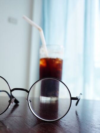 glasses on table and soft light from windowsの写真素材