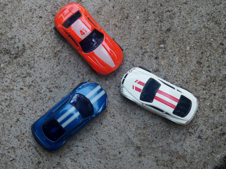 Toy cars on the asphalt. Toy cars on the road. Top view.