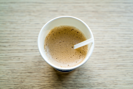 Coffee cup top view on wooden table backgroundの写真素材