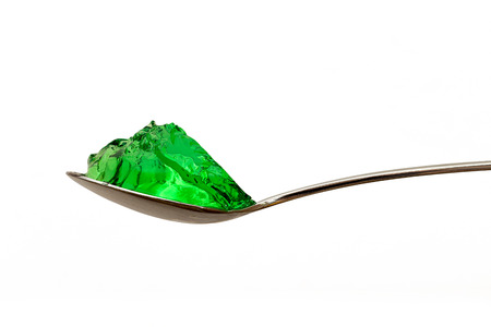 grenn jello on teaspoon isolatedの写真素材