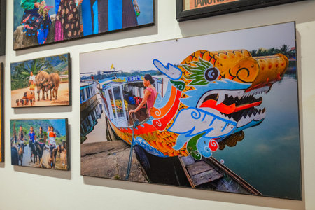 Woman smiling on a vibrant, colorful dragon boat docked by a river, showcasing traditional Vietnamese culture and river life, an eye-catching display of local craftsmanship and joyful expression. Red Gate Bakery Cafe Nha Trang, 26.11.2025, Vietnamのeditorial素材