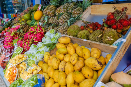 Vibrant tropical fruit market stall displaying an abundant variety of fresh, exotic fruits like mangoes, pineapples, durian, dragon fruit, rambutan, and guava. Nha Trang, 26.11.2025, Vietnamの写真素材