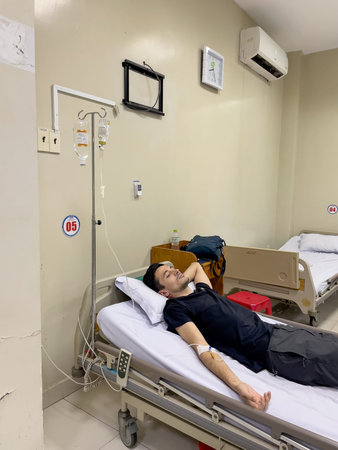 Patient resting during IV therapy in hospital ward, Nha Trang, October 18, 2025, Vietnamのeditorial素材