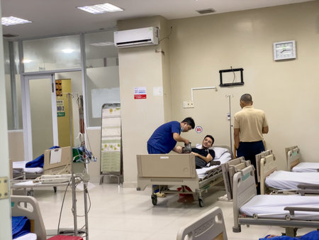 Medical staff attending to patient in hospital ward, Nha Trang 18.10.2025 Vietnamのeditorial素材