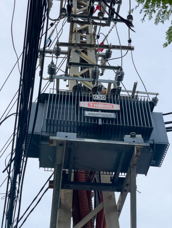 Technicians inspecting an open electrical box on a city street. Nha Trang, October 10, 2025, Vietnam.のeditorial素材