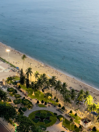 Aerial view of sandy beach with palm trees and people swimming in turquoise water in Nha Trang, October 17, 2025, Vietnamの写真素材