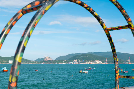 Coastal Landscape of Nha Trang Bay Vietnam with Traditional Fishing Boats and Vinpearl Resort View through Creative Frame and Natural Lighting Nha Trang 20.12.2025 Vietnamのeditorial素材