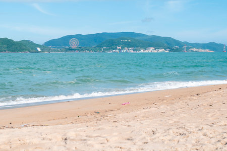 Tropical Nha Trang Beach View with Turquoise Sea and Vinpearl Land Park. Scenic Coastal Landscape with Natural Daylight and Wide Copy Space Background. Nha Trang 20.12.2025 Vietnamのeditorial素材