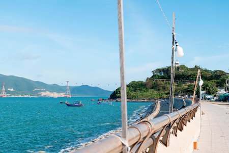Scenic Coastal Promenade in Vietnam with Turquoise Sea Fishing Boats and Cable Car under Bright Blue Sky with Depth of Field and Copy Space for Travel Ads Nha Trang 20.12.2025 Vietnamのeditorial素材
