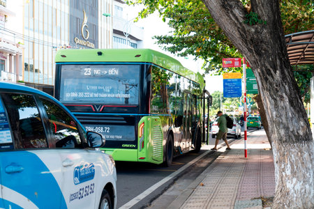 Modern Green Electric VinBus at Urban Transit Stop in Vietnam; Sustainable Public Transportation and Eco-Friendly Smart City Infrastructure in Sunlight Nha Trang 20.12.2025 Vietnamのeditorial素材
