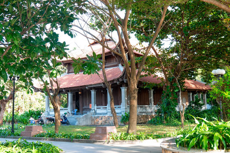 Traditional Vietnamese Wooden Temple with Red Tiled Roof in Lush Tropical Garden, Authentic Asian Architecture, Scenic Cultural Heritage, Bright Daylight Nha Trang 20.12.2025 Vietnamのeditorial素材