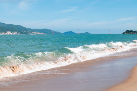 Pristine Tropical Beach with Turquoise Waves and Coastal Mountains in Nha Trang Vietnam - Bright Sunny Day Landscape with Natural Lighting and Copy Space Nha Trang 20.12.2025 Vietnamの写真素材