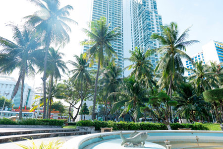 Modern High-Rise Apartment Building with Tropical Palm Trees and Sunny Sky in Nha Trang Vietnam Urban Oasis Landscape with Cinematic Lens Flare Nha Trang 20.12.2025 Vietnamのeditorial素材